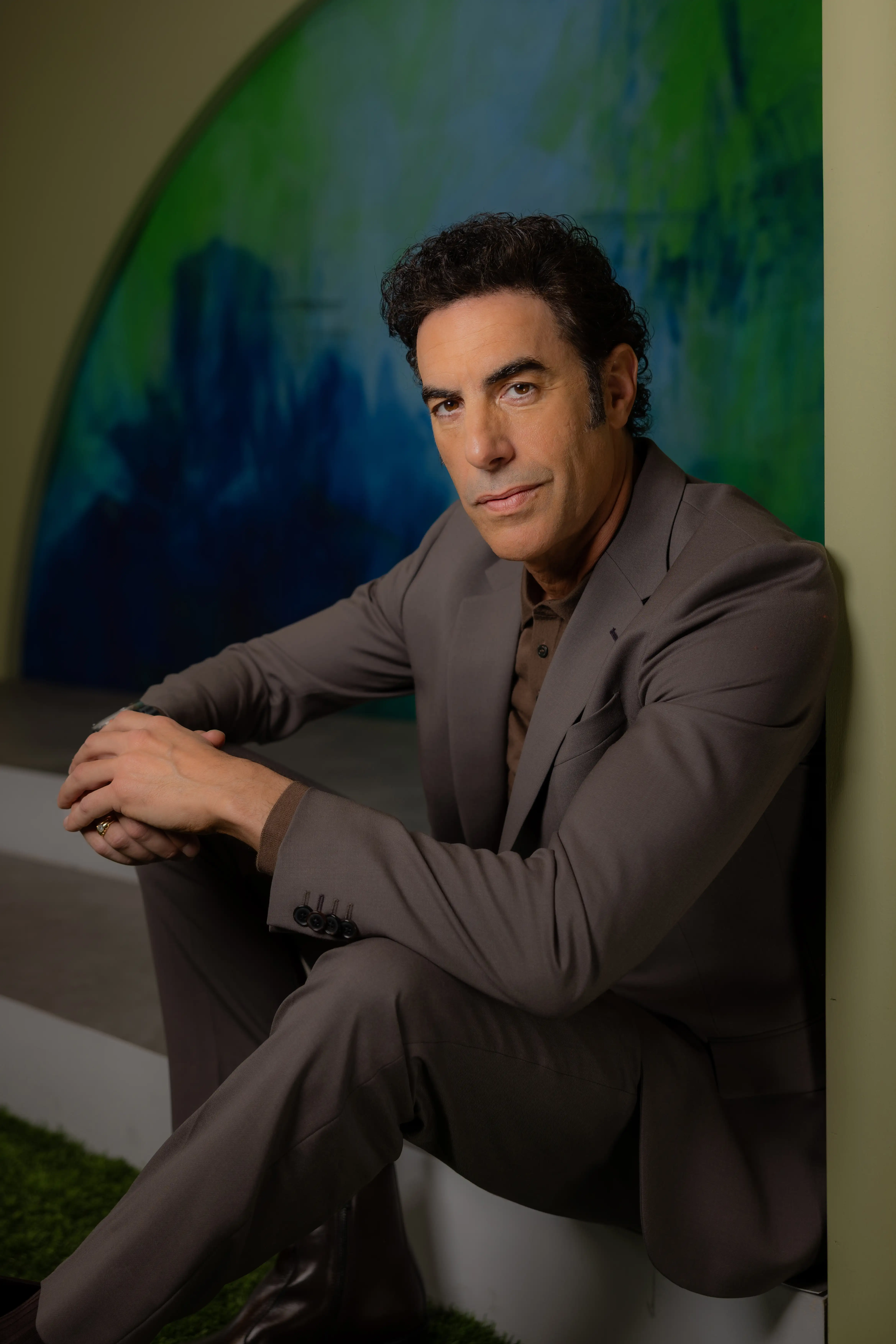 Sacha Baron Cohen in a brown suit, LA Times Envelope Emmy Roundtable, May 2025.