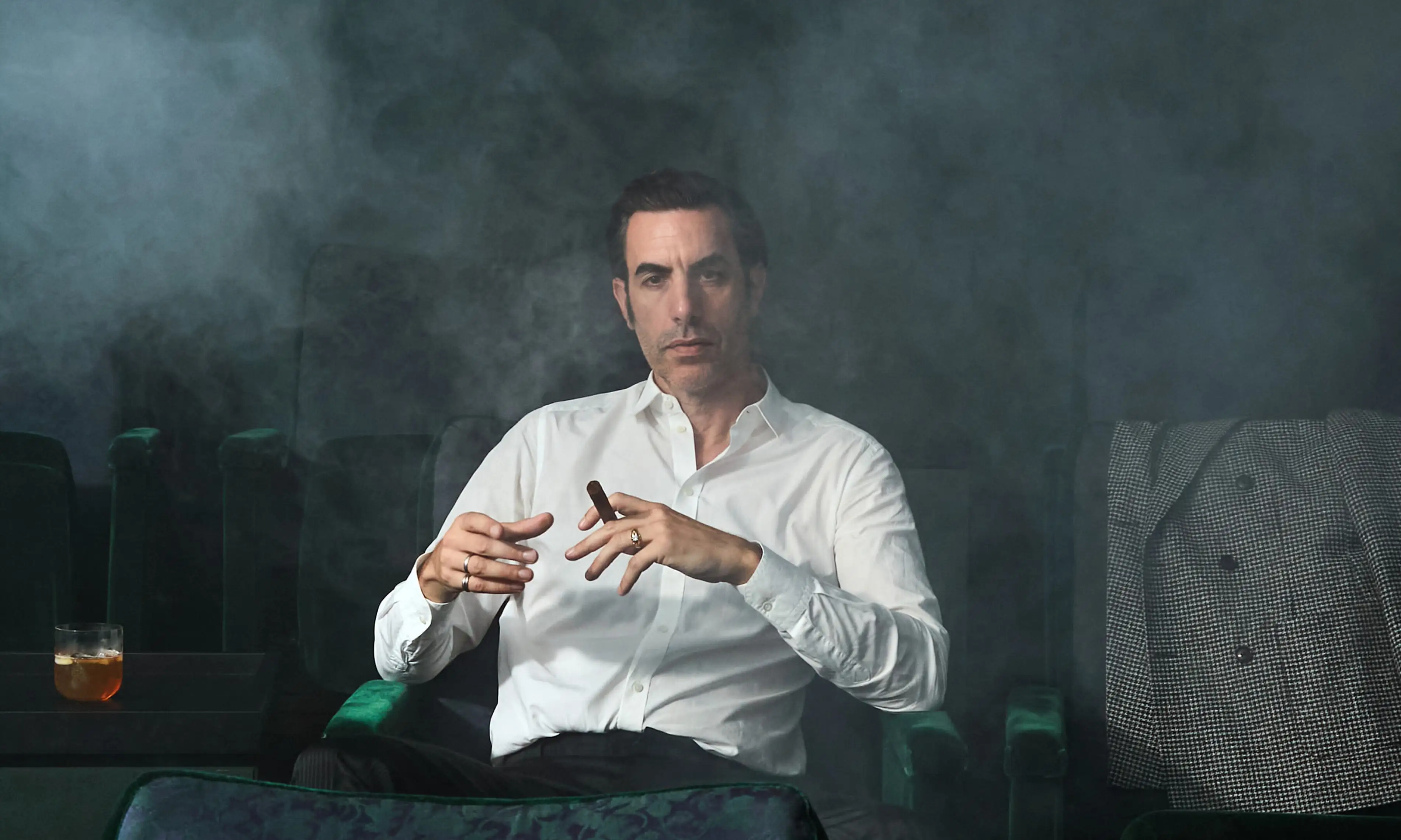 Sacha Baron Cohen seated in an empty cinema, The New York Times, 2020.