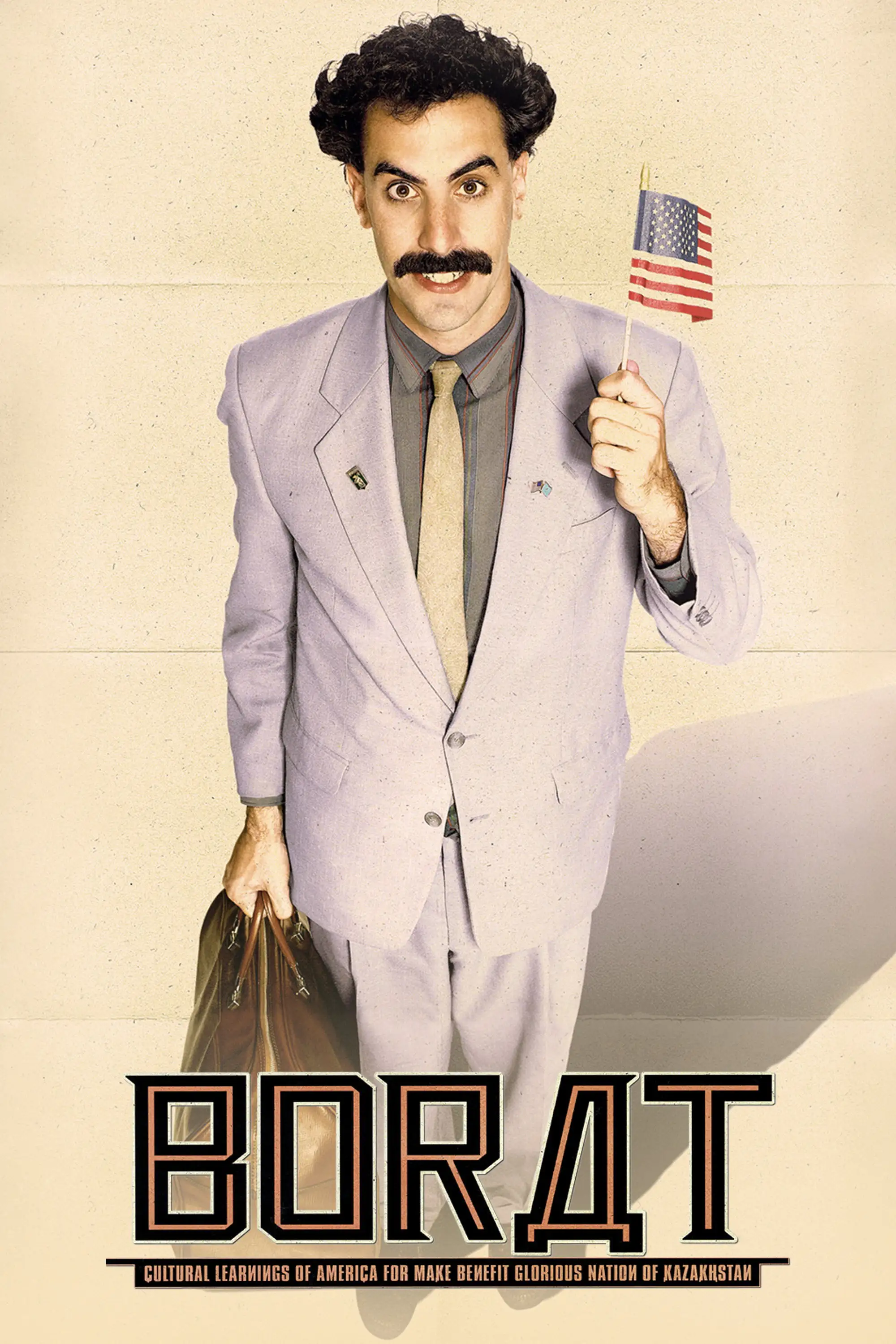 Sacha Baron Cohen as Borat on the 2006 theatrical poster, grey suit, small American flag and a suitcase.