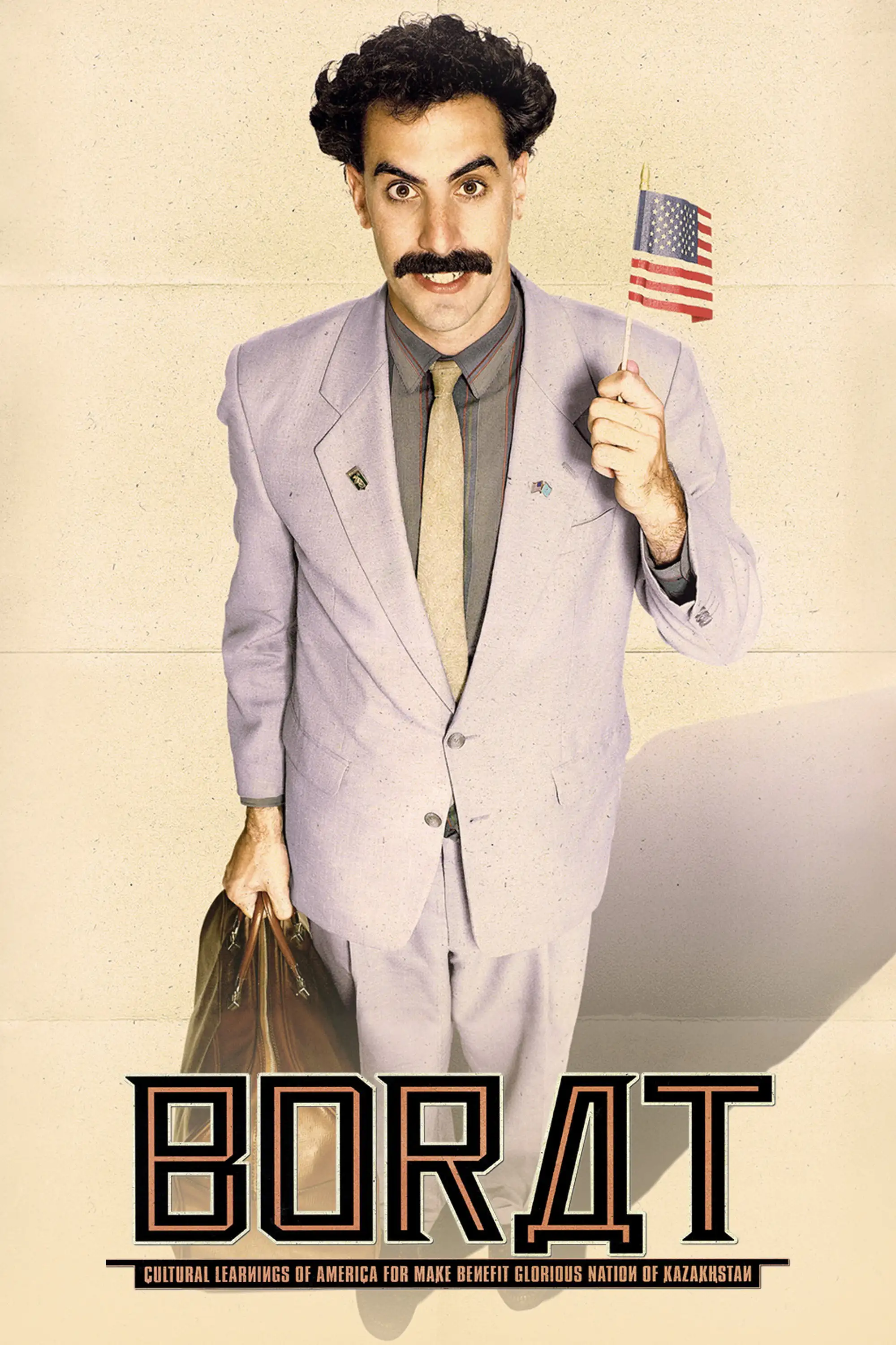 Sacha Baron Cohen as Borat on the 2006 theatrical poster, grey suit, small American flag and a suitcase.